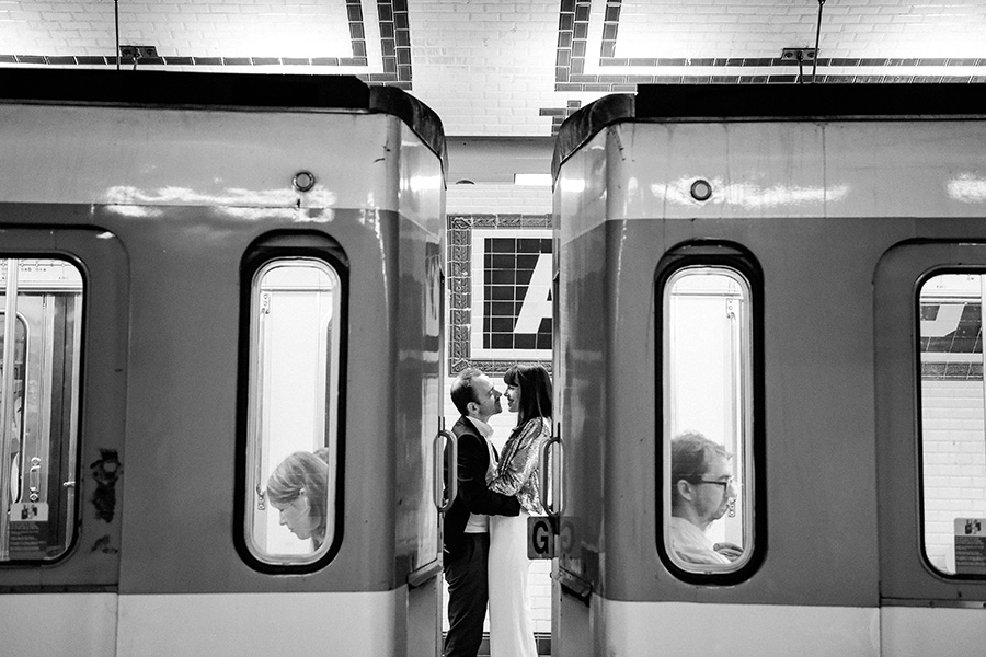 un couple s'enlace entre deux rames de métro