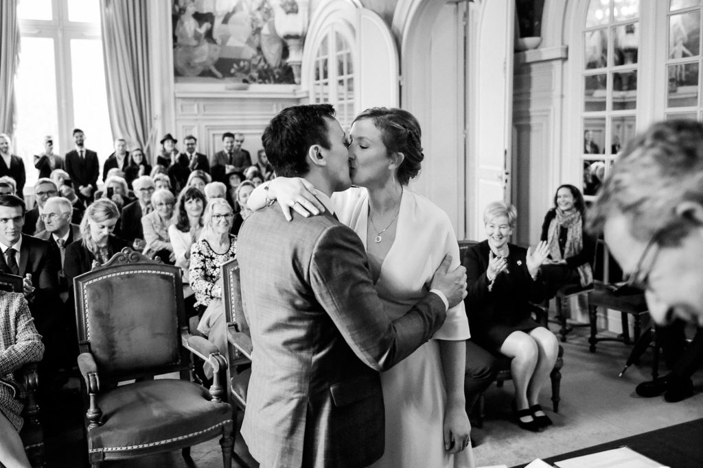 Les mariés s'embrassent dans la salle des mariages à la mairie